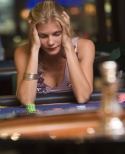 Woman losing at roulette table in casino